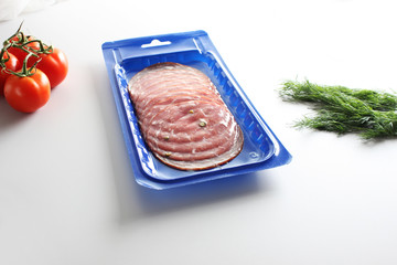 blue vacuum packing sausage cut on a light background