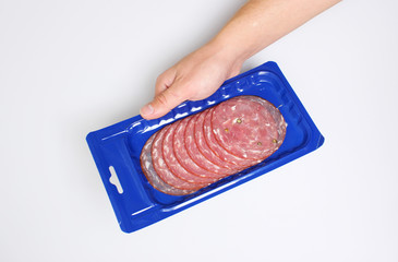 blue vacuum packing sausage cut hold hand