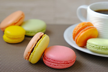 colorful macaroons on the table, coffee, sweets