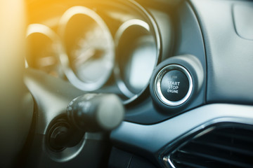 Close up start stop engine modern new car button