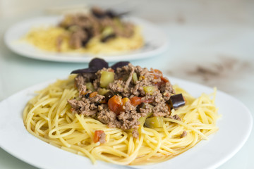 pasta with meat and vegetables on a plate, Italian dish