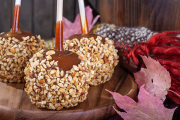 Closeup of Nutty Caramel Apple on a Rustic Background
