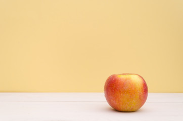 An apple on white wooden table