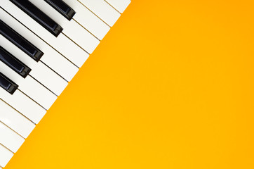 Abstract orange background with the piano keys in the up-left corner