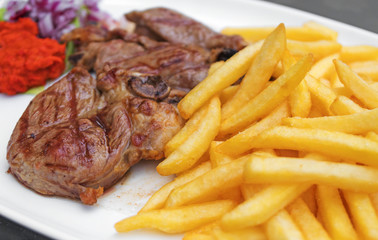 Rack of lamb with french fries.