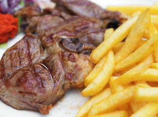 Rack of lamb with french fries.