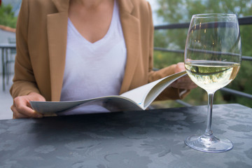 Woman with menu choosing dishes at restaurant.