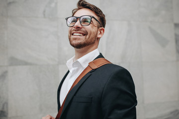 Close up of a smiling businessman looking away