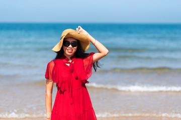 Woman by the seaside wearing red dress