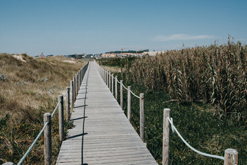 Fototapeta na wymiar Wooden bridge at the beach of Porto