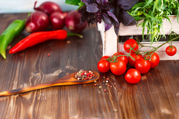 Cherry, tarragon, chili pepper, basil, spices Ingredients for cooking pasta. Food background on a wooden table