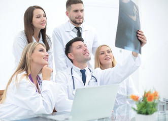 group of doctors discussing an x-ray ,sitting at the table.