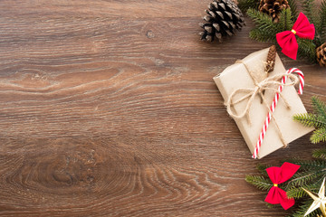 Christmas composition background on wood table with gift box and some decorations. Top view with copy space, flat lay.