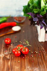 Cherry, tarragon, chili pepper, basil, spices Ingredients for cooking pasta. Food background on a wooden table