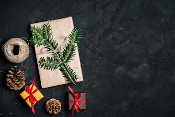 Gifts for new year wrapped in craft paper and spruce branch. Top view. Copy space.