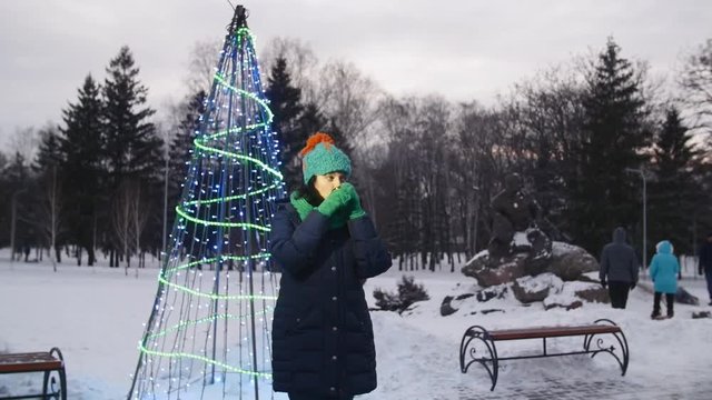 HD A girl is dring tea next to the christmas tree carcas in a park