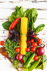 Cherry, tarragon, spaghetti, chili pepper, basil, spices Ingredients for cooking pasta. Food background on a white table