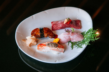 Premium mix sushi on white plate, Foie Gras sushi, Otoro sushi, Wagyu sushi, salmon sushi