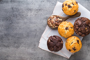 Homemade chocolate muffins on the vintage background.