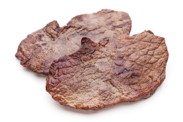 Grilled beef steaks with spices isolated on white background.