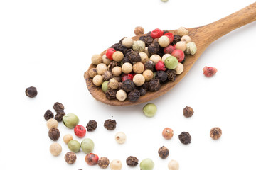Pepper mix seed on spoon on white background.