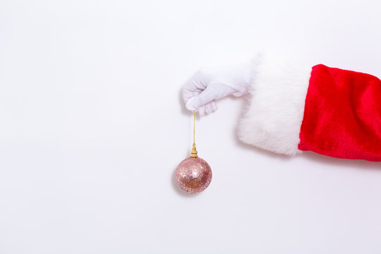 Santa Claus Holding A Pink Bauble On A White Background