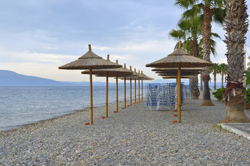 beach umbrellas made of bamboo on the banks of the sea