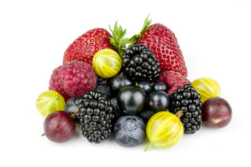 An assortment of summer berries is isolated on a white background.