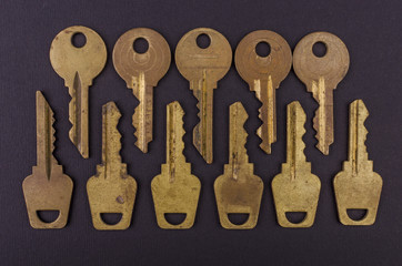 Old vintage keys on black background. Several types of old retro keys. Set of old keys. Composition of different keys.