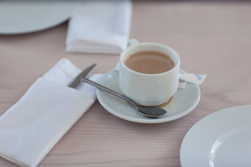 A cup of coffee on a light table