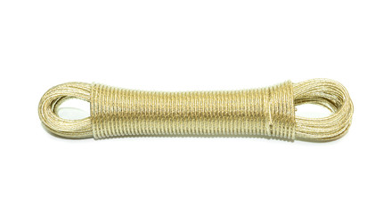 Close up view of yellow coiled rope tied neatly stored. Isolated on white floor.