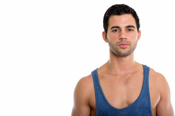 Studio shot of young handsome Hispanic man