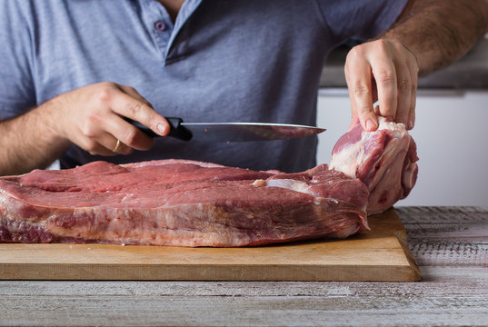 Man cutting beef meat