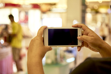 Woman Using smartphone in department store