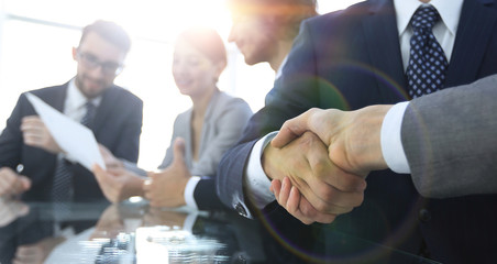 handshake of business partners in conference room