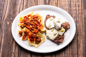 pasta with tomato sauce and mignon with cheese sauce