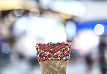 hand holding empty wafer cone