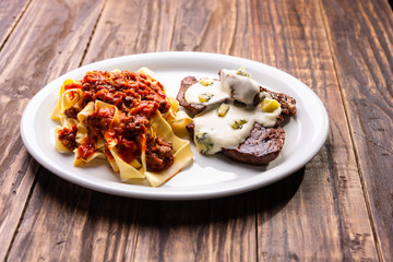 pasta with tomato sauce and mignon with cheese sauce