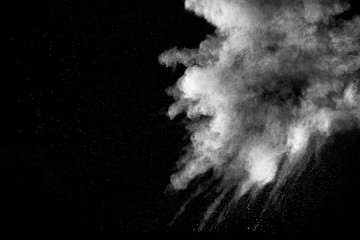 Explosion of white dust on black background.