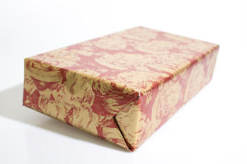 Christmas gift with red and gold paper isolated in a white background