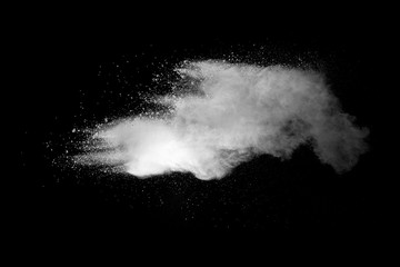 Explosion of white dust on black background.