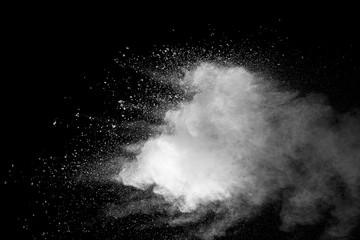 Explosion of white dust on black background.