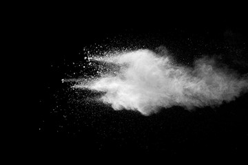 Explosion of white dust on black background.