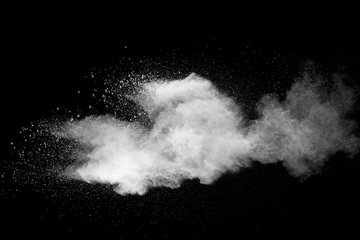 Explosion of white dust on black background.