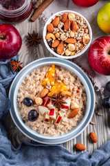 oatmeal with fruit and nuts, healthy breakfast, top view