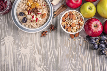 Fototapeta na wymiar oatmeal with fruit and nuts, healthy breakfast, top view, copy space