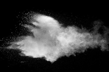 Explosion of white dust on black background.