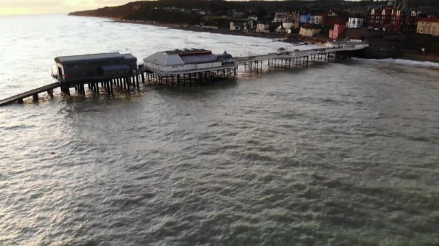 Aerial footage of cromer pier and town shot from the sea.