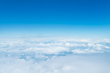 Naklejka na ściany i meble beautiful blue sky with cloud. Blue sky with clouds for background. Skyline View above the Clouds from air plane