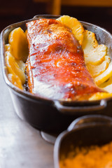 Crispy pork ribs with pineaple in an iron pan